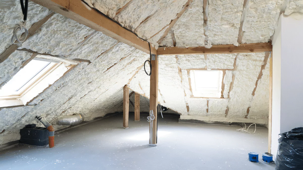 an attic with insulation on the walls and ceiling