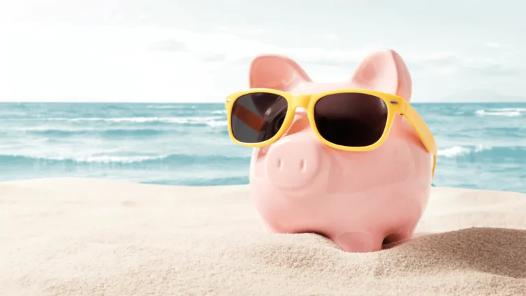 How to Save Money on Travel Without Sacrificing Comfort piggy-bank-resting-on-vacation-saving-money-travel-concept